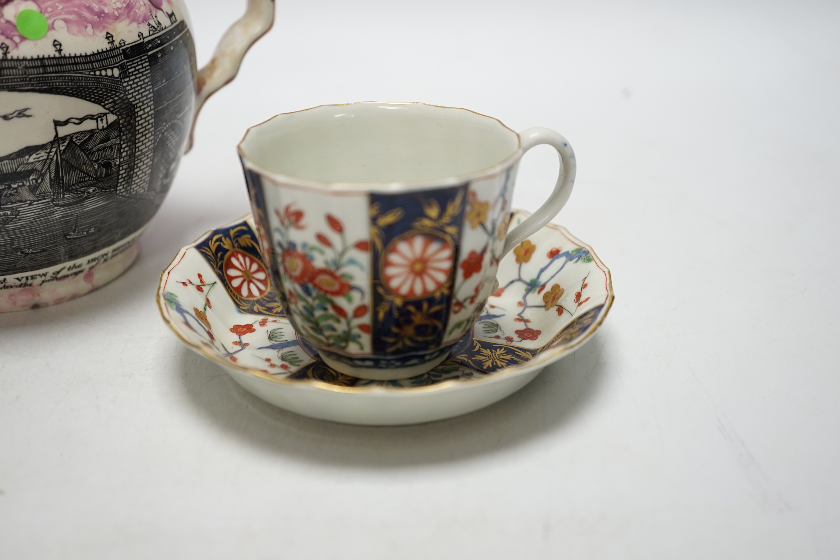 A Worcester Kakiemon pattern coffee cup and saucer, c.1780 and Gray’s Pottery pink lustre ‘’Iron Bridge Sunderland’’ jug, (3), 13cm